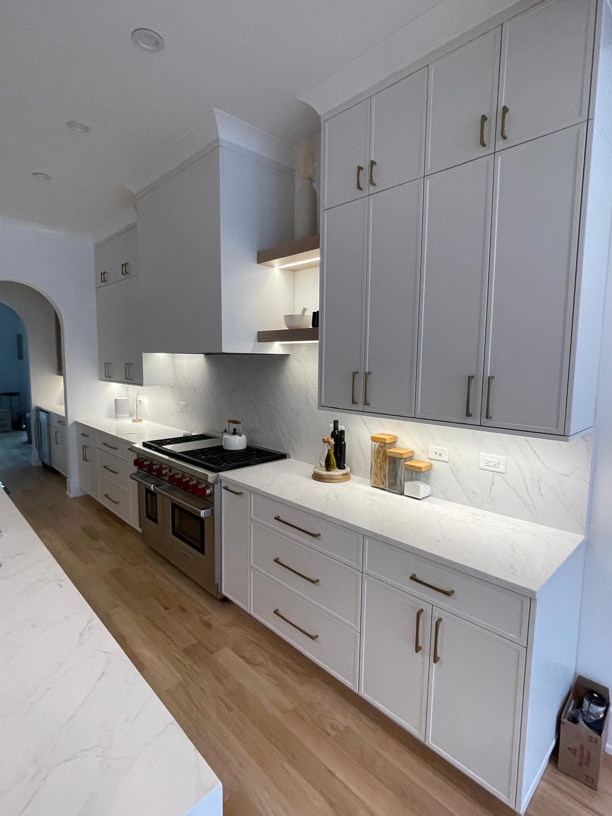 Custom kitchen cabinetry with gold hardware and quartzite countertops — luxury remodel by Epic Homes
